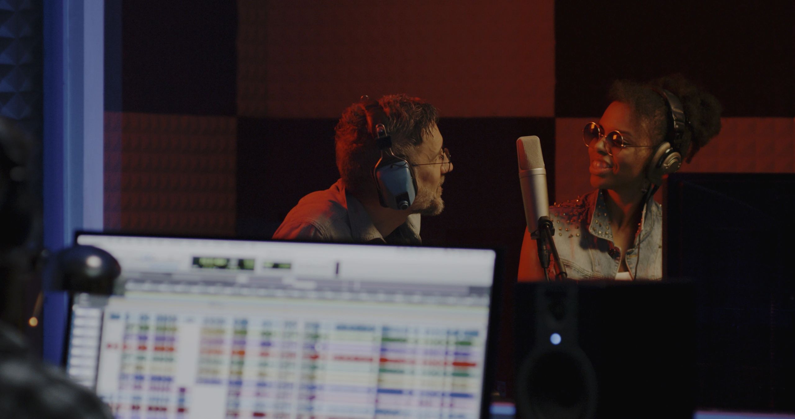 Creators and audio team working together in a recording studio