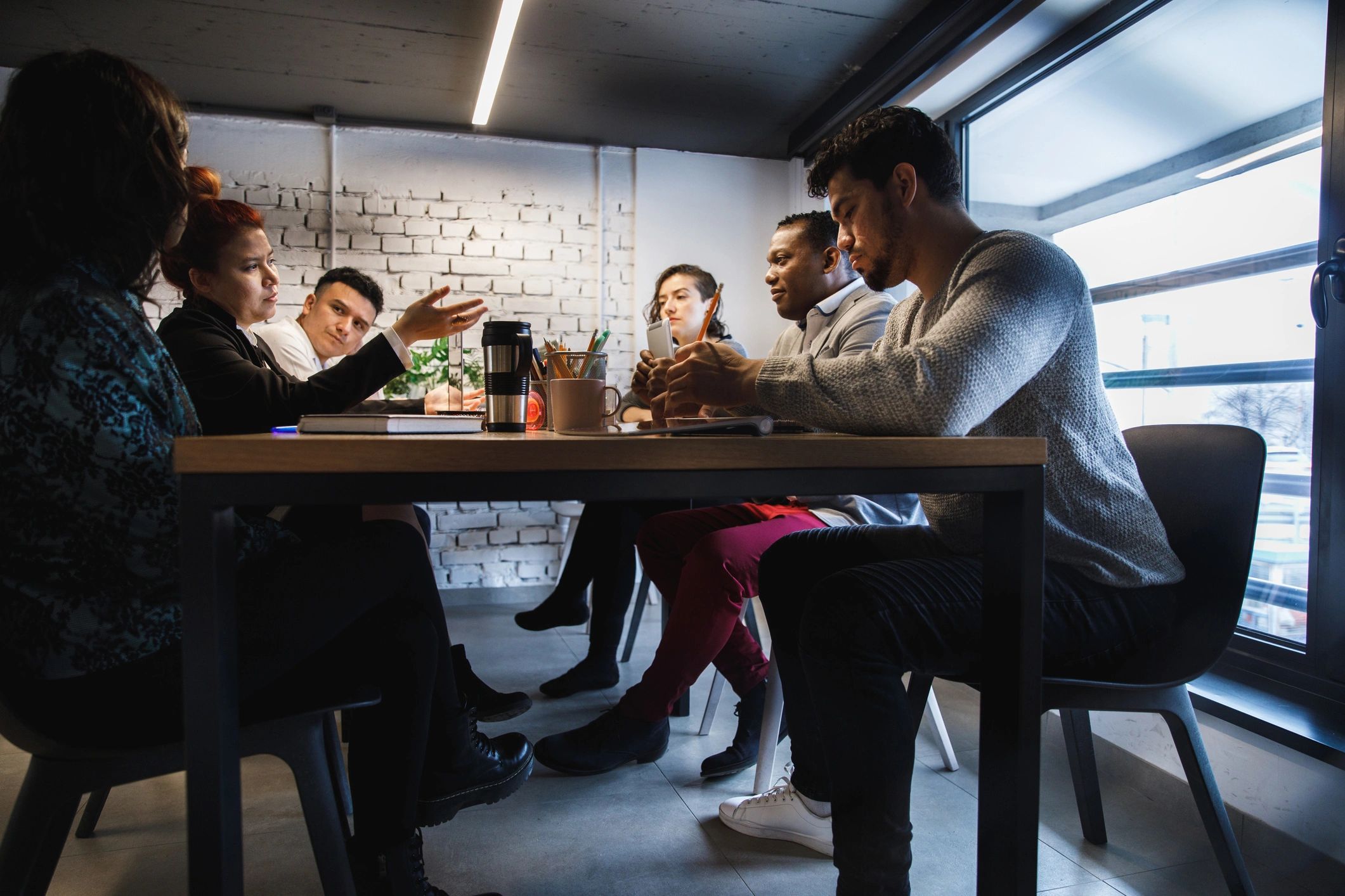 Podcast team meeting together in a collaborative workspace