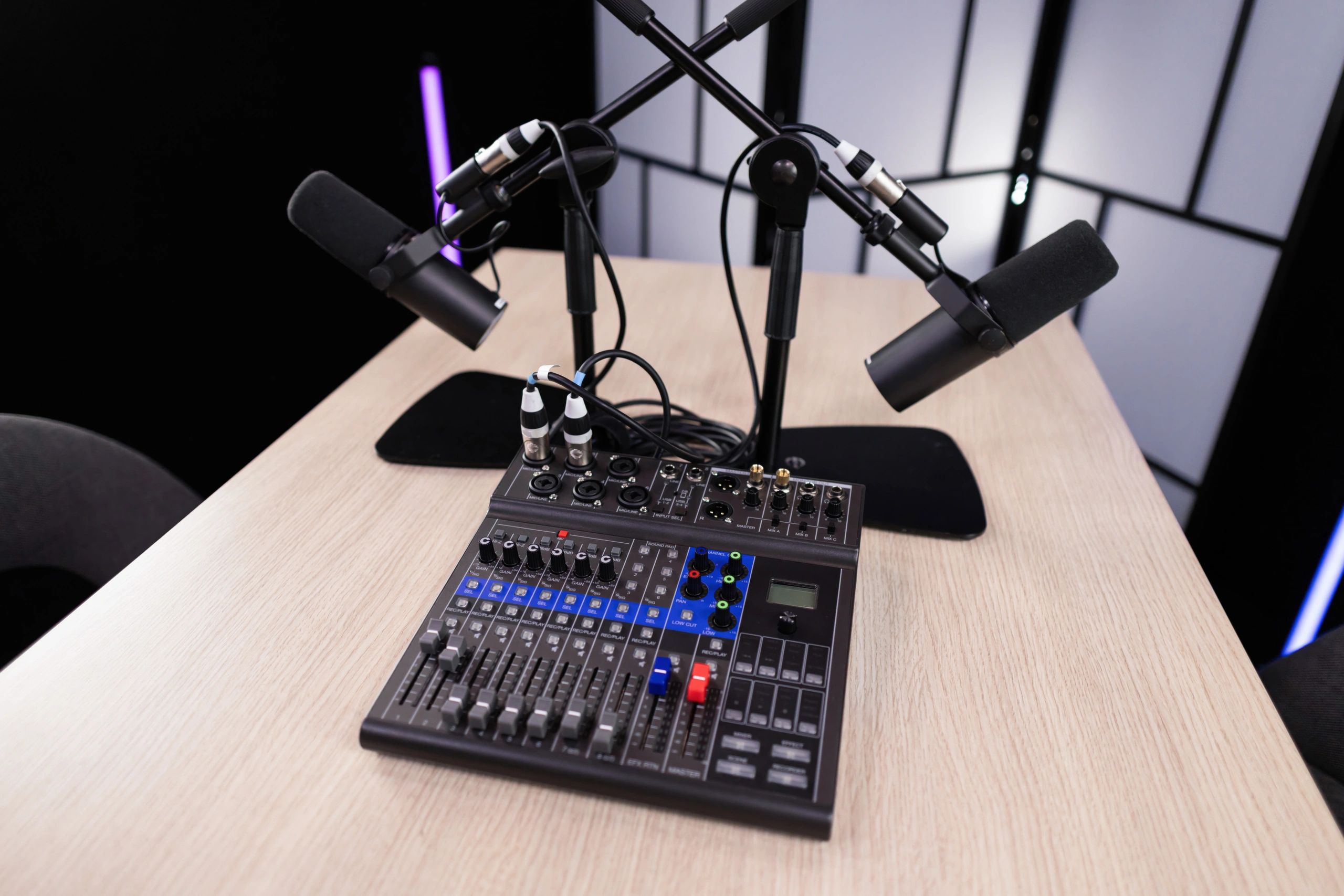 Professional podcast studio setup with microphones and mixing console ready for recording